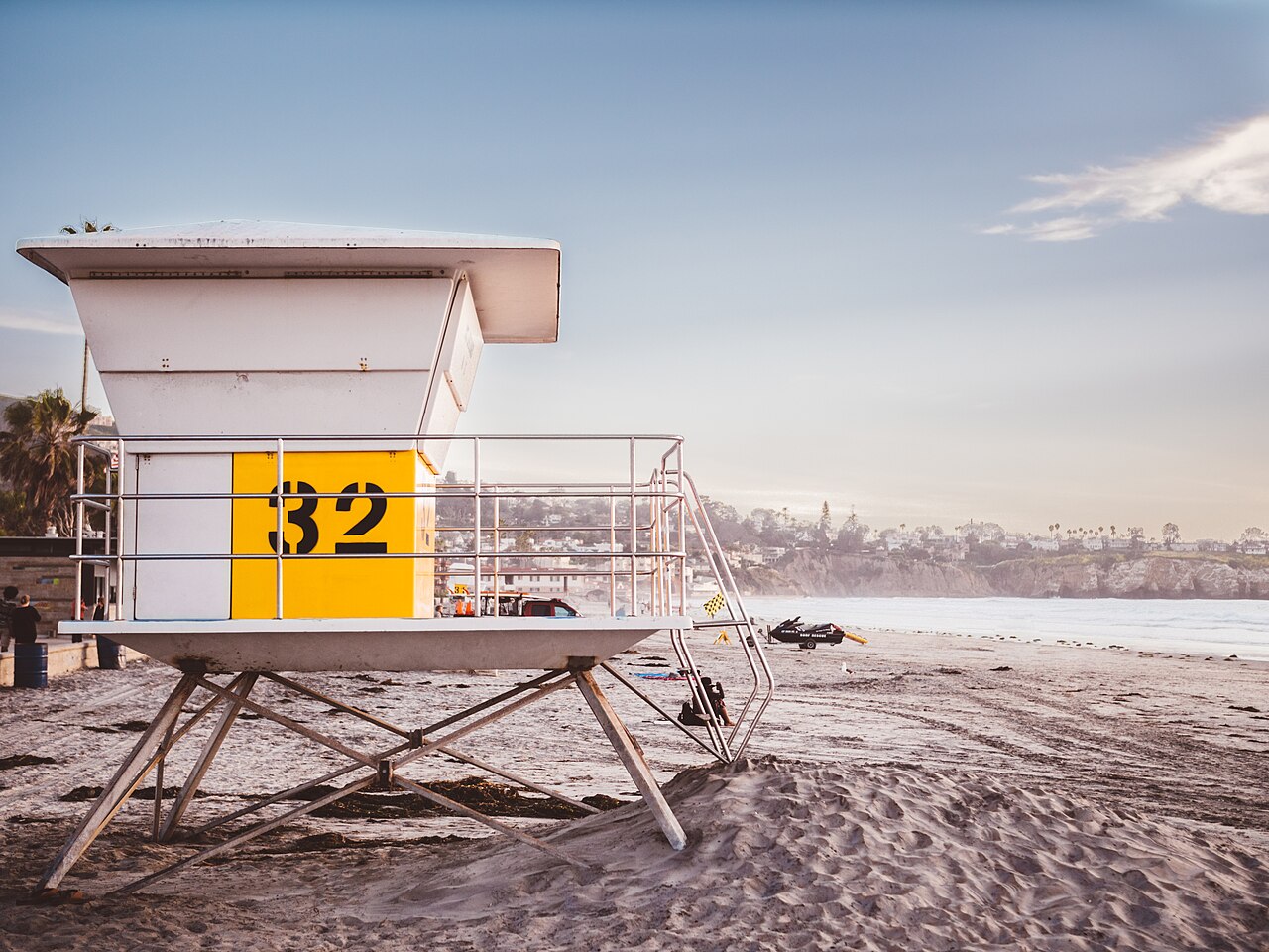 Lifeguard tower 32 on the wide sand at La Jolla Shores, with the bluffs to the south.